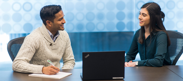 Man and woman sitting at an office table