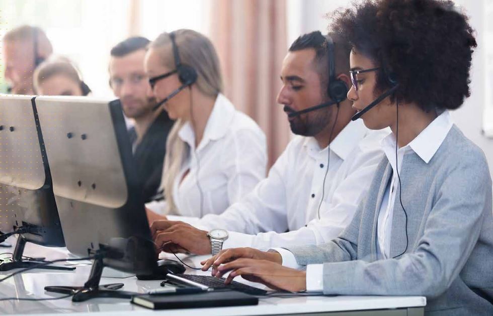 Telemarketers operating at computers. 