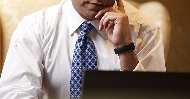 Business man sitting in front of a laptop computer